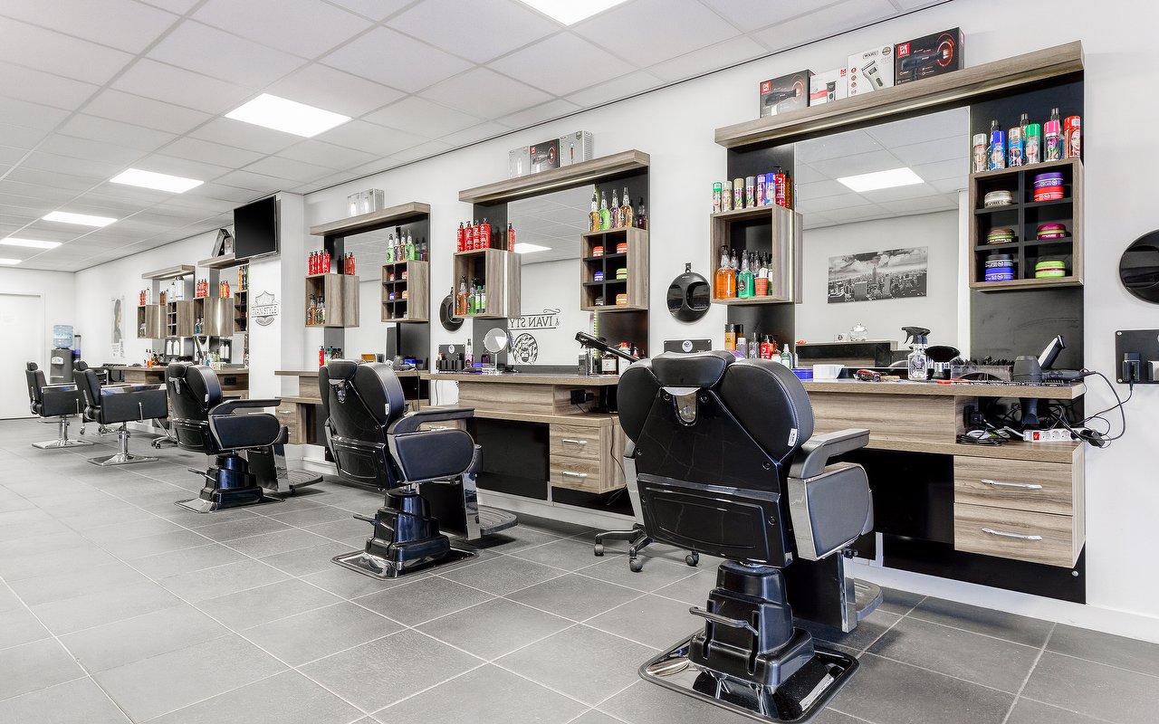 De rij zwarte kappersstoelen voor de spiegels in Kapsalon Ivan Style
